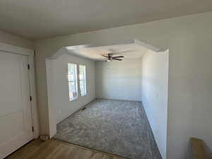 Unfurnished room with a textured ceiling, ceiling fan, and light hardwood / wood-style floors