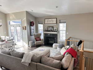 Living room with french doors, wood-type flooring, and a textured ceiling