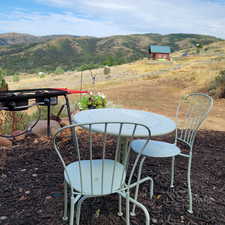 View of yard with a rural view and a mountain view