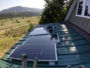 Exterior space with solar panels and a mountain view