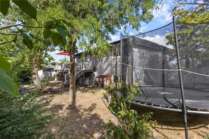 Exterior space featuring a wooden deck and a trampoline