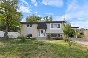 Raised ranch featuring a front lawn