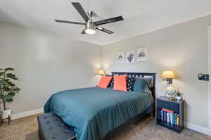 Bedroom with ceiling fan and carpet floors