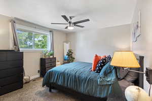 Carpeted bedroom with ceiling fan