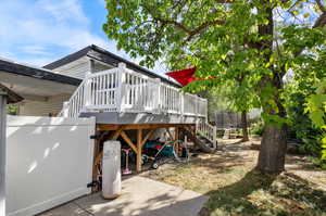 View of yard with a trampoline and a deck