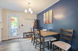 Dining room featuring an inviting chandelier and hardwood / wood-style floors