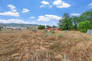 Exterior space featuring a mountain view and a rural view. Back half acre, potential horse or animal space