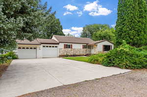 Ranch-style home with a 2 car garage with extra storage closet, and an extended driveway