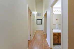 Hallway with light hardwood / wood-style floors