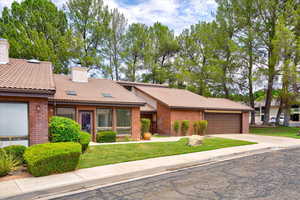 View of front facade featuring a front yard and a garage