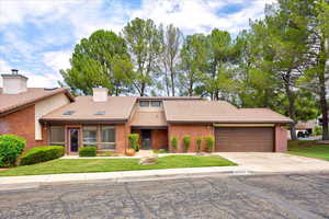 View of front facade with a front lawn and a garage