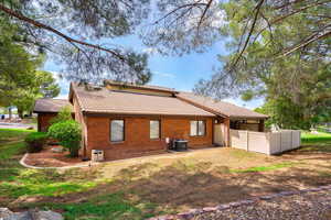 Rear view of property featuring cooling unit