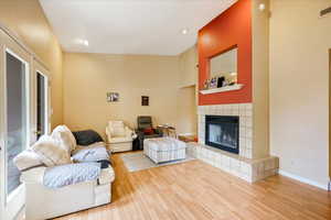 Living room featuring a tiled fireplace and hardwood / wood-style floors