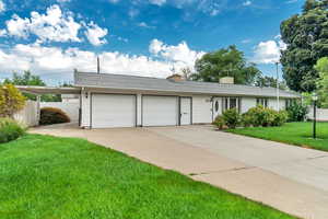 Ranch-style home with a front lawn and a garage