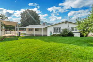 Rear view of house featuring a patio area and a yard