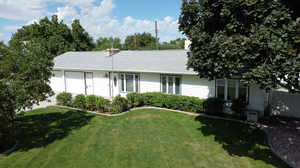 Ranch-style house with a garage and a front yard