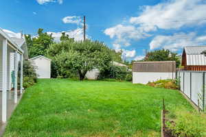 View of backyard featuring two storage sheds