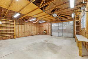 Inside of Detached Garage featuring automatic garage door and work table