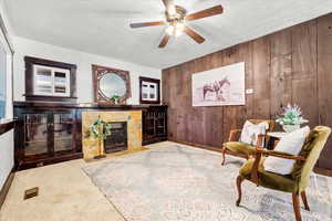 Living Room featuring fireplace and built-in glass front cabinets on both sides of the fireplace and custom wood accent wall