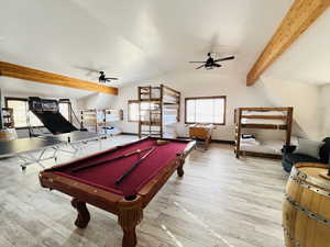 Rec room with pool table, wood finished floors, vaulted ceiling with beams, and a ceiling fan