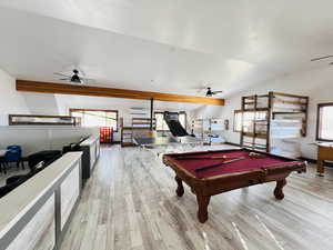 Rec room with light wood-style floors, pool table, lofted ceiling, and a ceiling fan