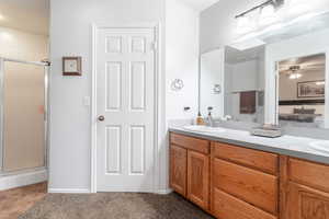 Bathroom with dual vanity, ceiling fan, walk in shower, and tile patterned flooring