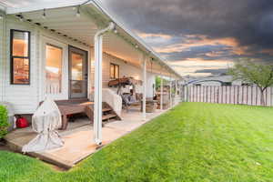 Yard at dusk featuring a patio