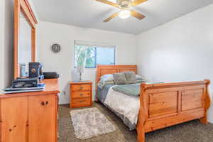 Carpeted bedroom with ceiling fan