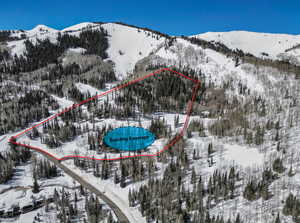 Snowy aerial view featuring a mountain view