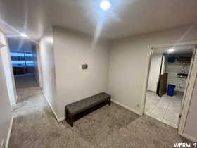 Corridor with light tile patterned flooring