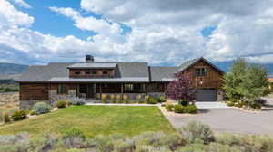 View of front of property featuring a garage and a front yard