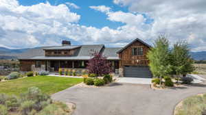 View of front of house featuring a front yard and a mountain view