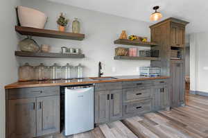 Kitchen featuring light hardwood / wood-style flooring, stainless steel appliances, and sink