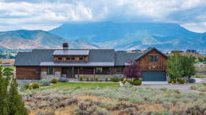 View of front of home featuring a garage and a mountain view