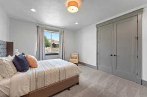 Carpeted bedroom with a textured ceiling