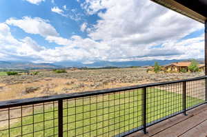 Balcony featuring a mountain view and a rural view