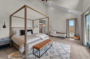 Bedroom featuring high vaulted ceiling and light carpet