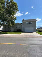 View of front of home featuring a front lawn and a garage