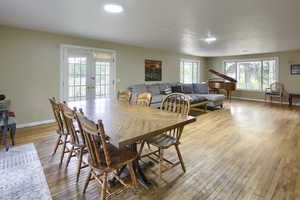 Dining area with light hardwood / wood-style flooring and french doors