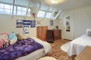 Bedroom with light wood-type flooring and multiple windows