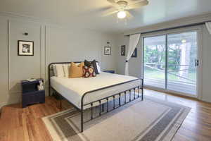 Bedroom featuring ceiling fan, light wood-type flooring, crown molding, and access to exterior