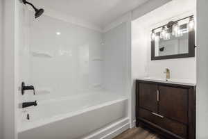 Primary Full Bathroom with wood-type flooring, vanity, and  shower combination