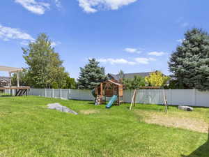 View of yard featuring a playground.