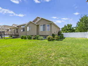 Exterior space with a wooden deck and a yard.