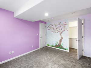 Large basement bedroom #4, the tree paiting glows in the dark with a black light. Carpet floors and closet organizer.