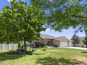 View of front of home featuring a garage and a front yard.