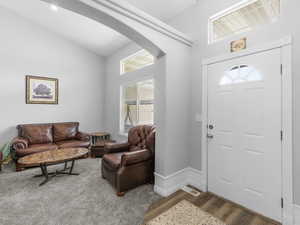 Entrance foyer with vaulted ceiling and seperate sitting area, carpeted and LVP flooring.