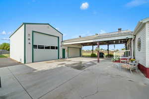 View of garage and covered patio