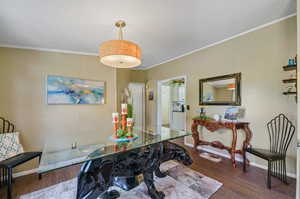 Dining area featuring wood-type flooring, a textured ceiling