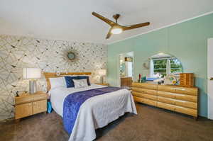 Bedroom featuring ceiling fan, a textured ceiling, carpet floors, and connected bathroom